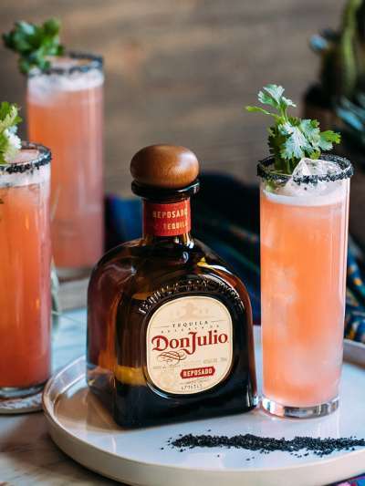 Don Julio Reposado Bottle on a plate with a Cocktail