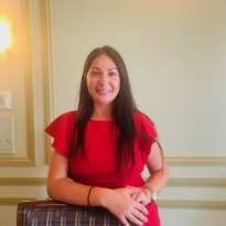 Woman Dark Long Hair, Red Dress, Leaning on a chair