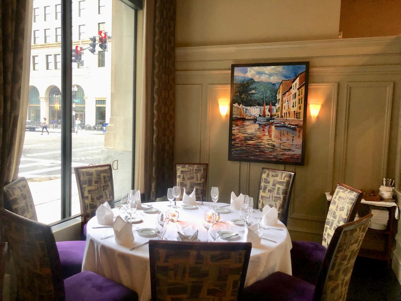 A round table for 8 next to a sunny window